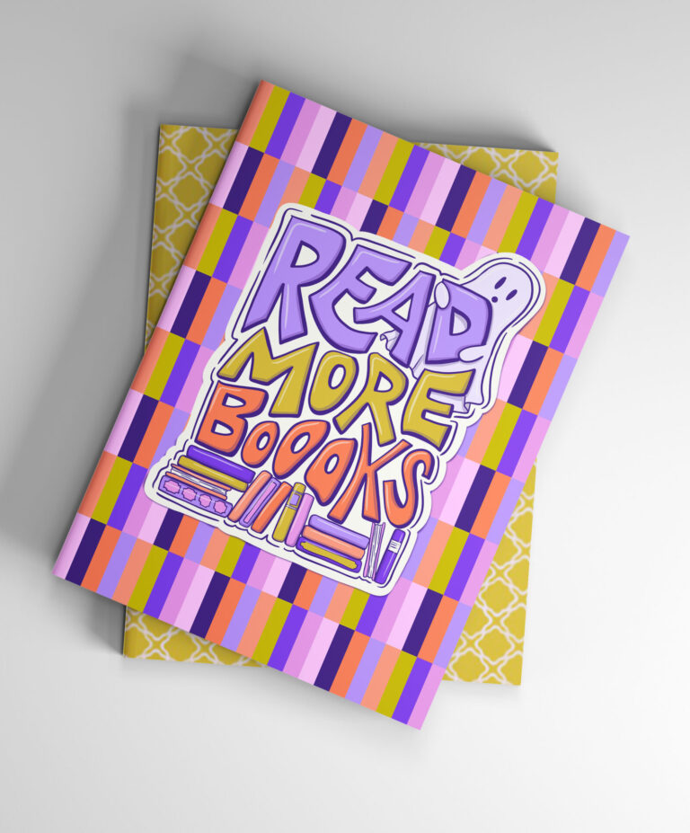 Notebook with colorful striped cover featuring the phrase ‘Read More Books’ in playful purple, red, and yellow lettering with book illustrations and a tiny ghost